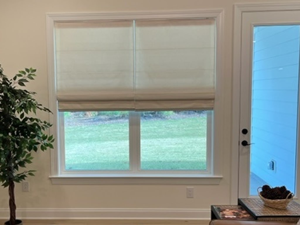 Roman Shades installed on living room windows.